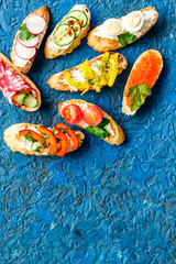 Sandwiches frame for menu design on blue background top-down copy space