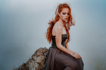 beautiful furious scandinavian warrior ginger woman in grey dress