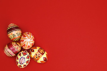 colored, floral easter eggs on a red background, place for text. Easter holiday.