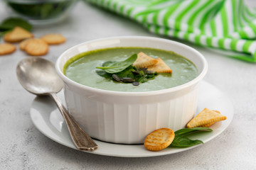 Spring, healthy creamy vegetable soup on bright table. Healthy detox food. Vegetarian food.