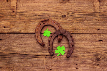 Two cast iron metal horse horseshoes, felt clove leaves. Good luck symbol, St.Patrick's Day concept