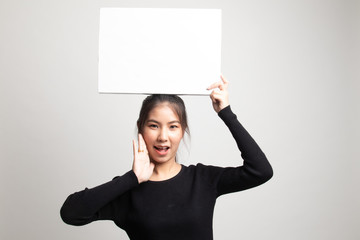 Young Asian woman surprise with white blank sign.