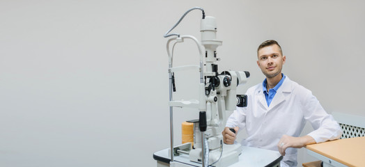 Young beautiful doctor/eye specialist/optometrist in an ophthalmologic clinic