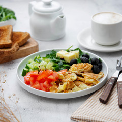 Fresh omelette for breakfast with mixed vegetables, toast brerad and cup of coffee. Square image.