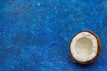 Ripe coconut cut on two half isolated on bright blue marine background