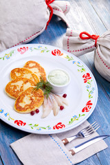 potato cutlets with sauce and herring