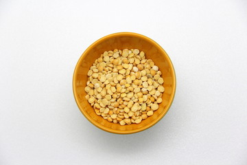 Ceramic bowl with peas on a white background, top view