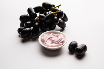 Black grapes, yogurt and honey mix face mask or cream forskin dark spot removal treatment, created using Angoor extract, curd and honey. selective focus