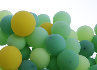 Green, light green and yellow balloons. A lot of balloons.