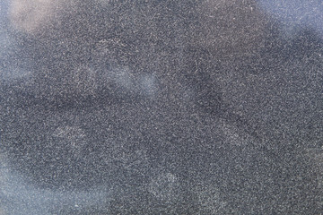 Dusty dirty glass of a car in zoom.