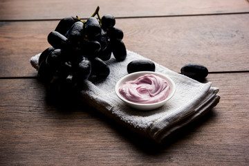 Black grapes, yogurt and honey mix face mask or cream for skin dark spot removal treatment, created using Angoor extract, curd and honey. selective focus