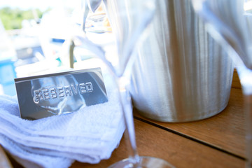 Romantic luxury evening on cruise yacht with champagne setting. Empty glasses and bottle with champagne and tropical sunset with sea background