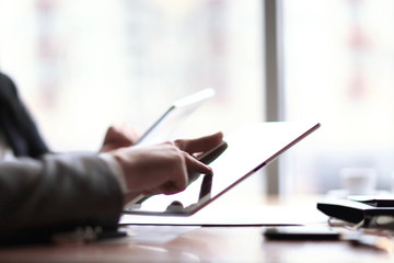businessman clicks on the screen of a digital tablet