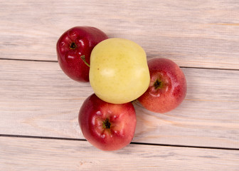 Apples karany and green on a wooden background