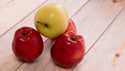 apples karany and green on a wooden background