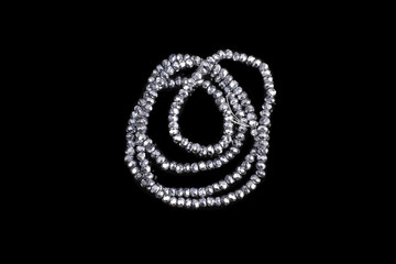 Obraz premium Natural stone beads on a black background isolated