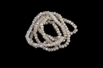 Natural stone beads on a black background isolated