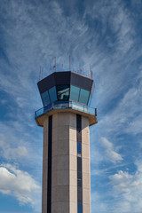 Control tower at a small regional airport against a clear blue sky