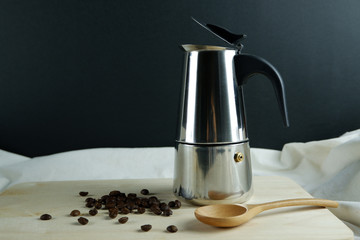 Americano coffee beside moka pot and black bean