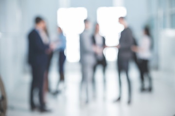 background image of a group of corporate employees in the office lobby
