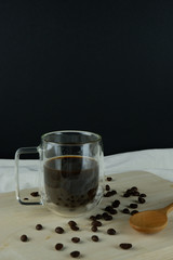 Americano coffee beside moka pot and black bean