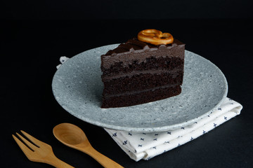 Close up view of sliced chocolate cake on top with pretzel