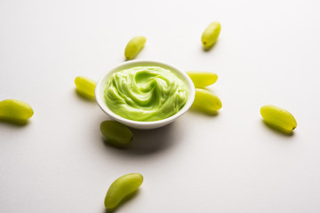 Green grapes, yogurt and honey mix face mask or cream for skin dark spot removal treatment, created using Angoor extract, curd and honey. selective focus