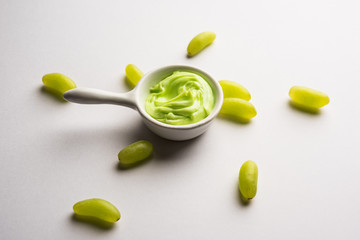 Green grapes, yogurt and honey mix face mask or cream for skin dark spot removal treatment, created using Angoor extract, curd and honey. selective focus