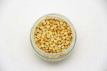 Glass jar with peas on a white background, top view