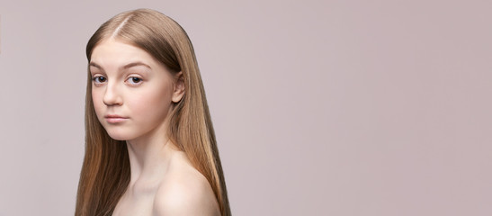Naklejka premium Young pretty woman studio portrait. Cosmetology concept. Esthetic woman face. Skin care dermatology beauty contour. Harmony girl. For cream, lotion horizontal banner. Copyspace