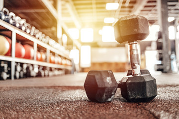 Sports equipment in gym. Dumbbells on the floor. Closeup image of a fitness equipment in gym. Gym...