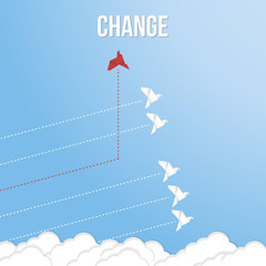 Think differently concept. Be different. Red bird changing direction. New idea, change, trend, courage, creative solution, innovation and unique way concept	