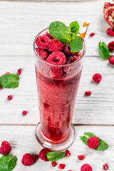 Raspberry smoothie in a glass, long glass with mint