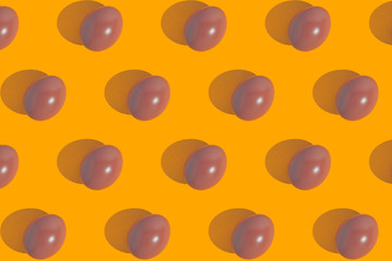 Modern minimalistic easter pattern. Pink eggs on yellow background.