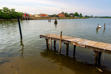 Old wooden fishing pier at the Lagoon of Comacchio, Province of Ferrara, Region of Emilia-Romagna, Italy, summer evening view