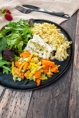 cod fish with vegetables, small vegetables and marine sauce