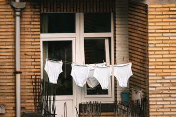 Hanging clothes - big large clean XXL white men's underwear on a balcony apartment in Brussels Belgium