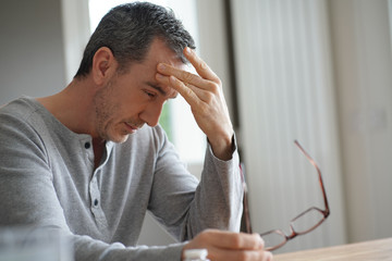 Portrait of man having migraine