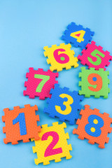 Soft block numbers children toys on blue background. Education concept. Creative concept. Flat lay, copy space, top view.