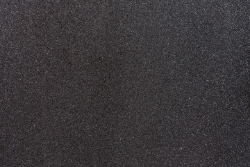 Gray background with reflections of the sun because of the iron filings carried by the paint.