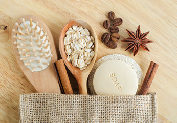 Wooden hairbrush, spoon with oatmeal, coffee beans, star anise, soap bar and loofah sponge. Natural beauty treatment, skip-care or zero waste concept. Top view, copy space.