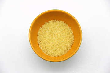Ceramic bowlwith rice on a white background, top view. The concept of healthy nutrition, diets, vegetarian products. Stock photo with empty space for text and design.
