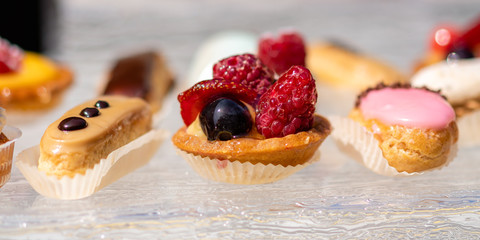 Dessert platter with chocolate eclair and fruit pie