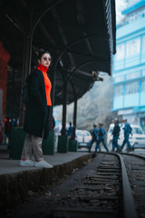 Fototapeta na wymiar A girl sitting on the train tracks