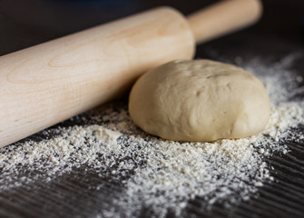Fototapeta na wymiar The dough and rolling pin