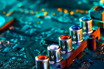 Electronic circuit board with electronic components such as chips close up. Blurry background.