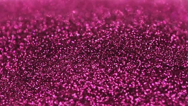 Pink cosmetics make-up glitters light flares, close-up