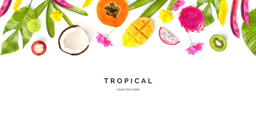 Creative layout made of coconut, papaya, dragonfruit, lime, kiwi, mango, mangosteen and tropical leaves and flowers on the white background. Flat lay. Food concept. Macro  concept.