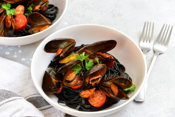 Black spaghetti. Black seafood pasta with mussels. Mediterranean delicacy food. black pasta with cuttlefish ink, recipe Italian food, spanish food. selective focus and copy space
