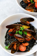 Black spaghetti. Black seafood pasta with mussels. Mediterranean delicacy food. black pasta with cuttlefish ink, recipe Italian food, spanish food. selective focus and copy space